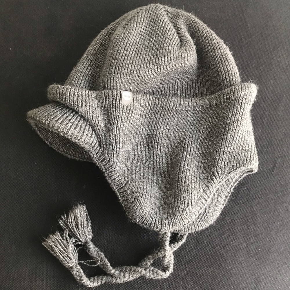 Timberland 100% acrylic billed beanie with ear flaps and under chin tie strings
